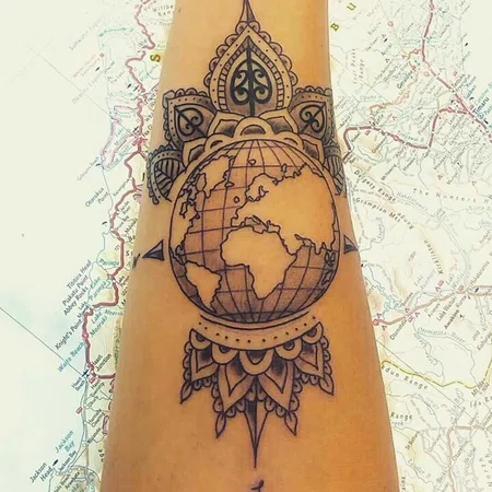 Globe tattoo on forearm for women