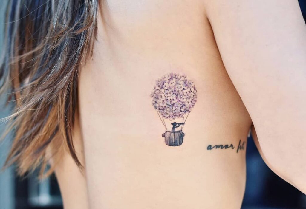 Balloon tattoo on the side for women