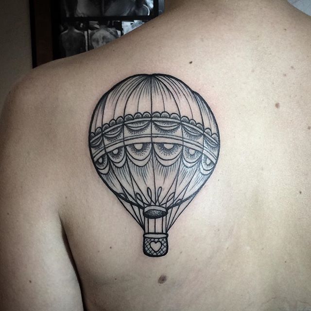 Balloon tattoo on the shoulder blade for men