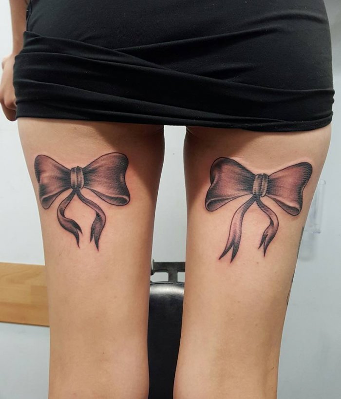 Bow tattoo on leg for women