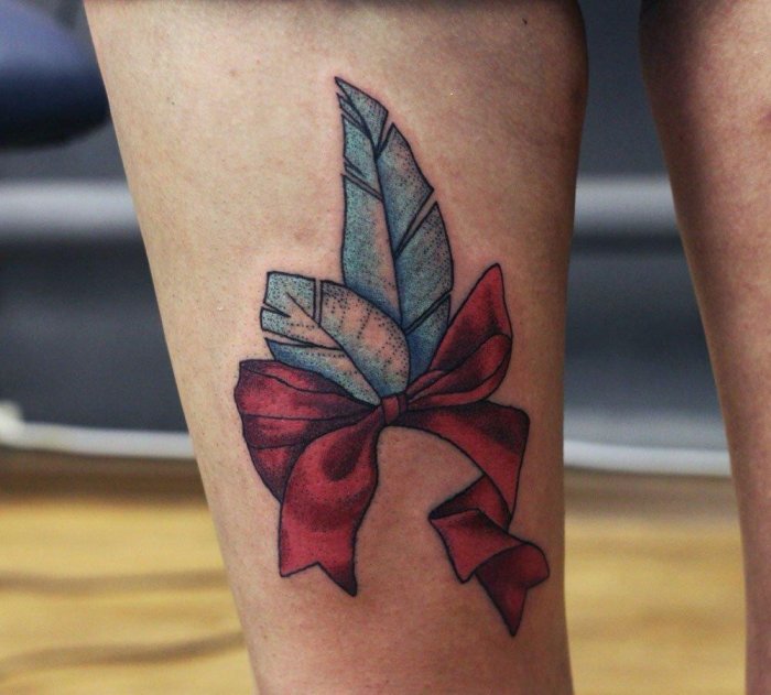 Bow tattoo on leg for women