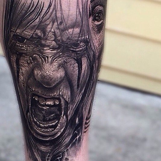 Horror style tattoo on the leg for men