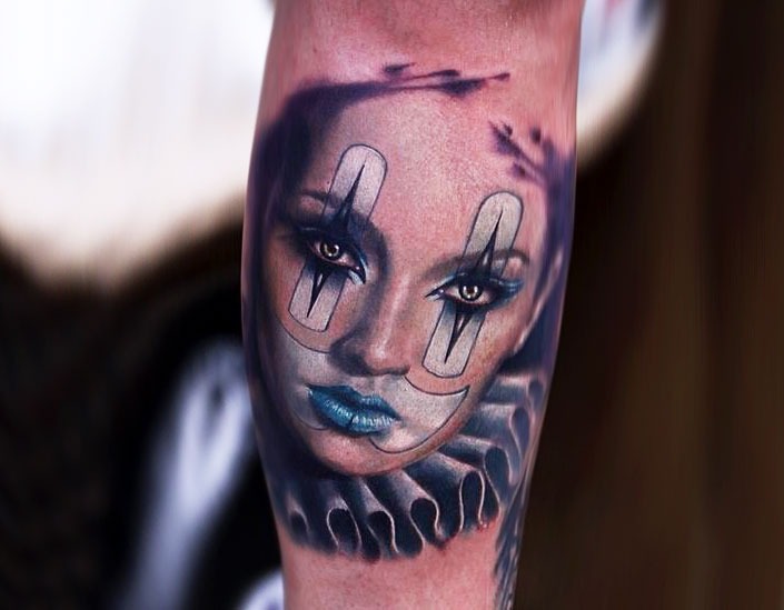 Harlequin tattoo on leg for women