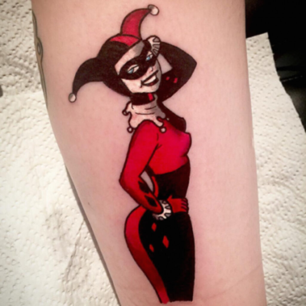 Harlequin tattoo on leg for women