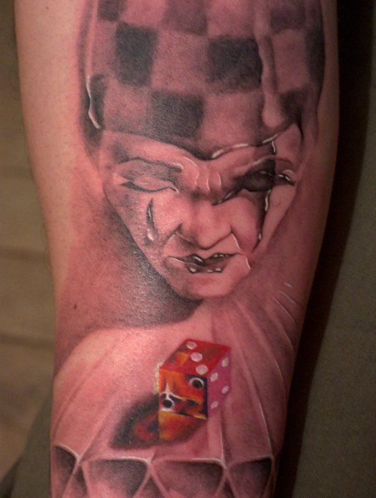 Harlequin tattoo on leg for men