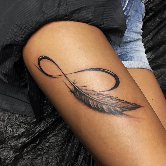 Infinity tattoo on thigh for women