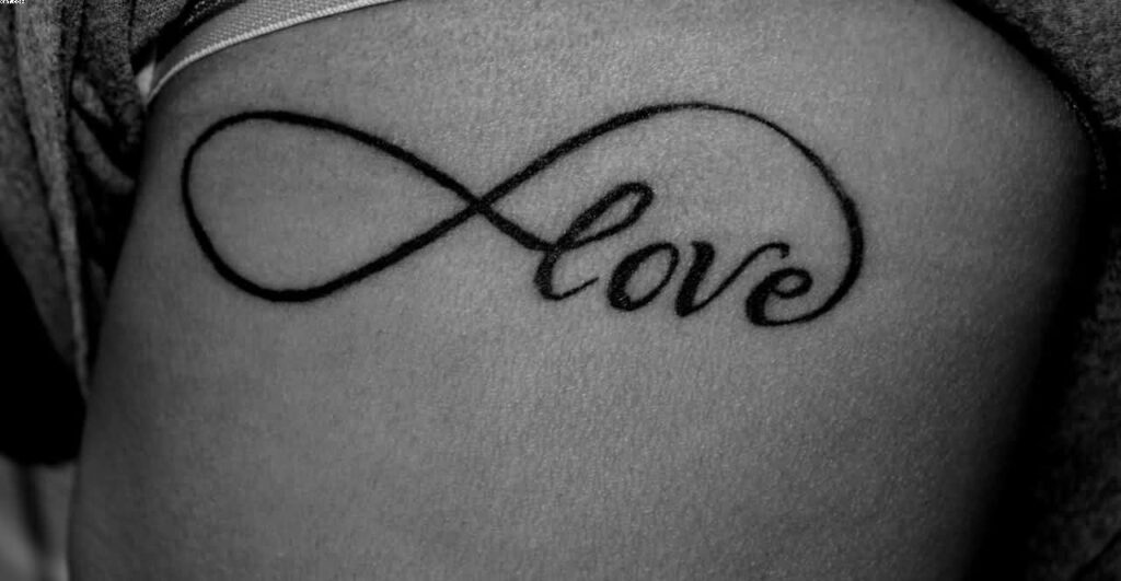 Infinity tattoo with writing on arm for women