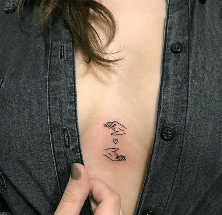 Minimalist style tattoo on the chest for women