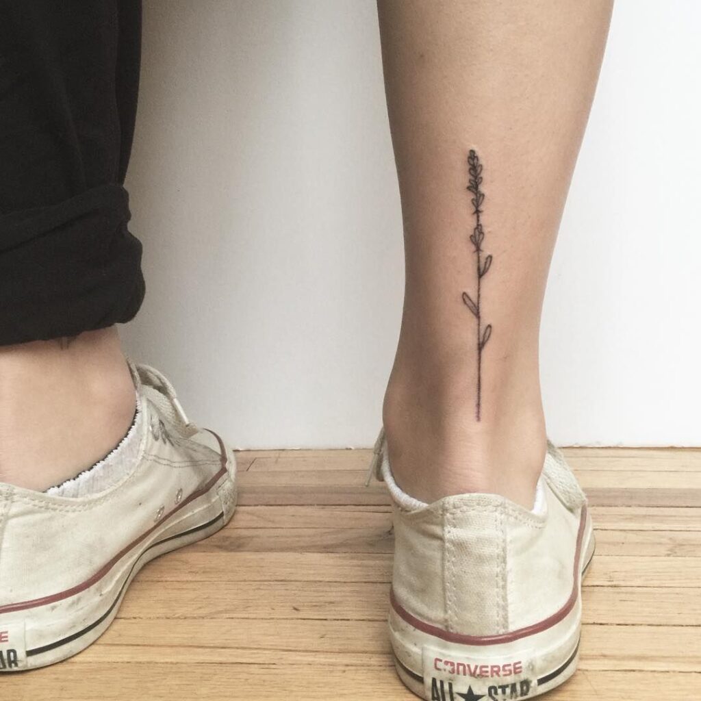 Minimalist style tattoo on the calf for women