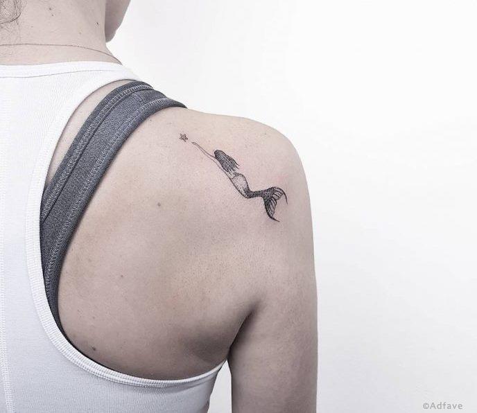 Minimalist tattoo on the shoulder for women