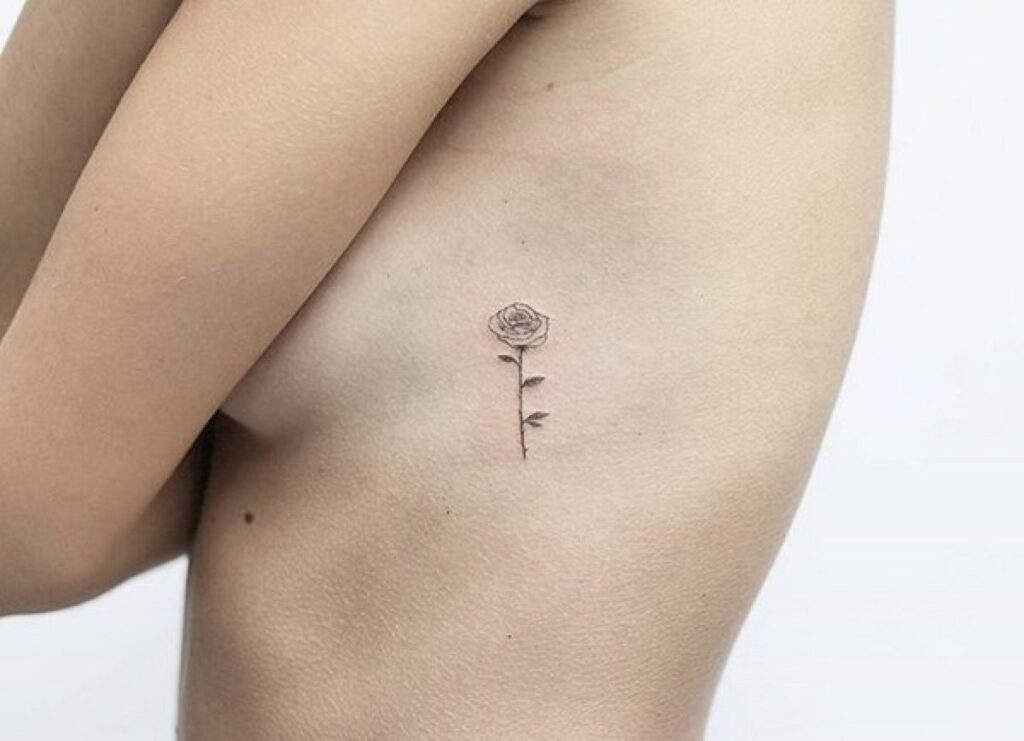 Minimalist rose tattoo on the side for women