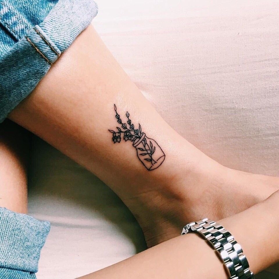 Minimalist style tattoo on the lower leg for women