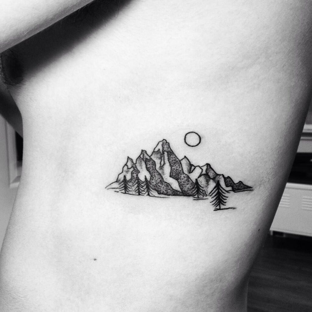 Mountain tattoo on the side for women