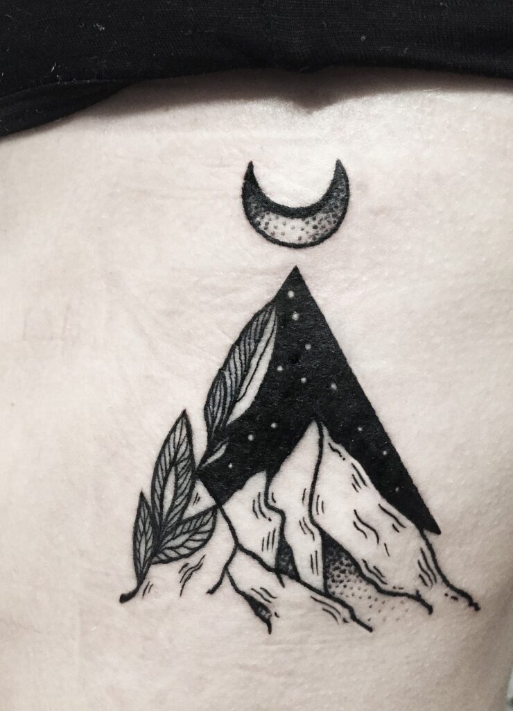 Mountain tattoo on stomach for women