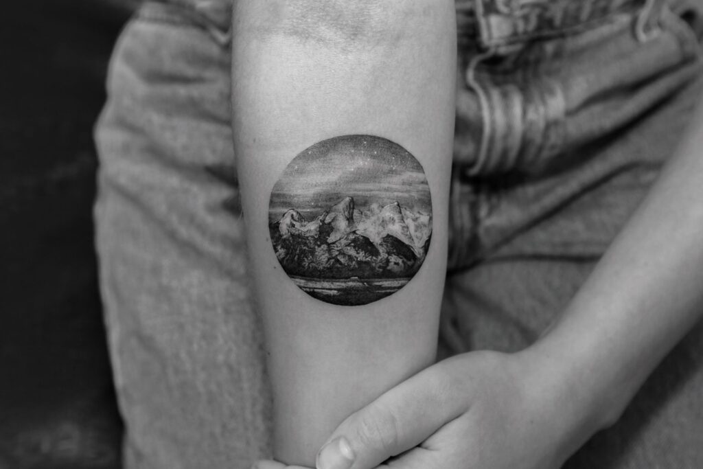 Mountain tattoo on forearm for women