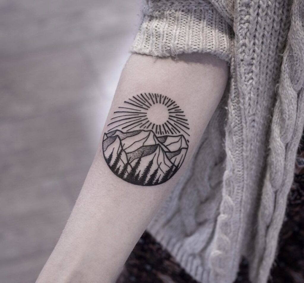 Mountain tattoo on arm for women