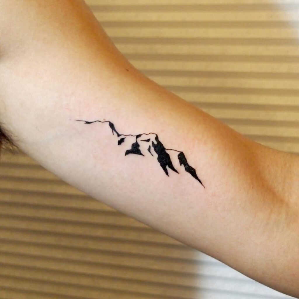 Mountain tattoo on arm for women