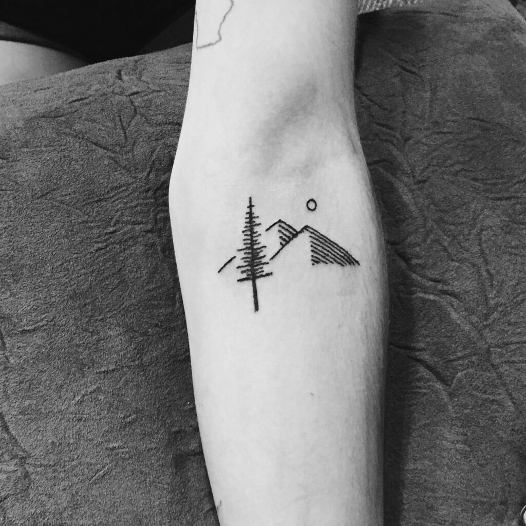 Mountain tattoo on forearm for men