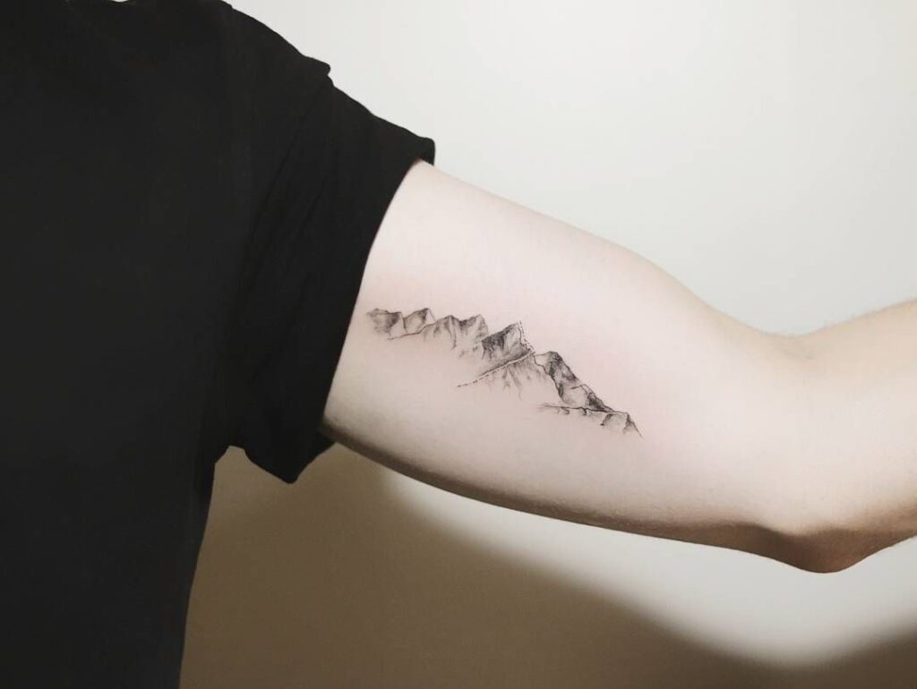 Mountain tattoo on arm for men