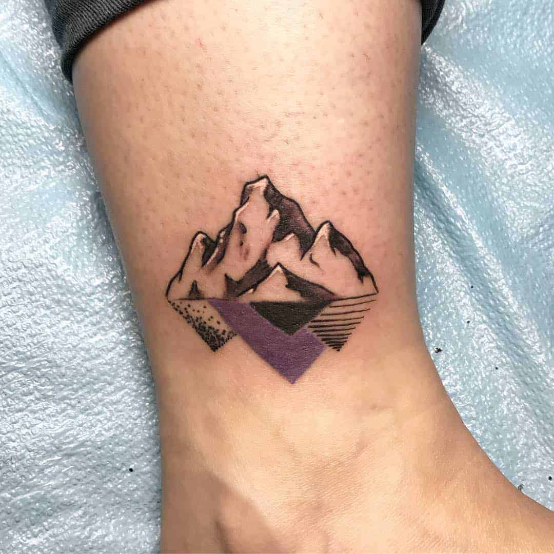 Mountain tattoo on shin for women