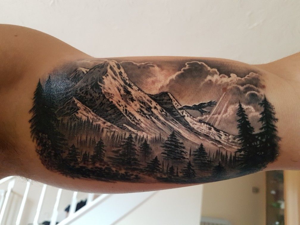 Mountain tattoo on bicep for men