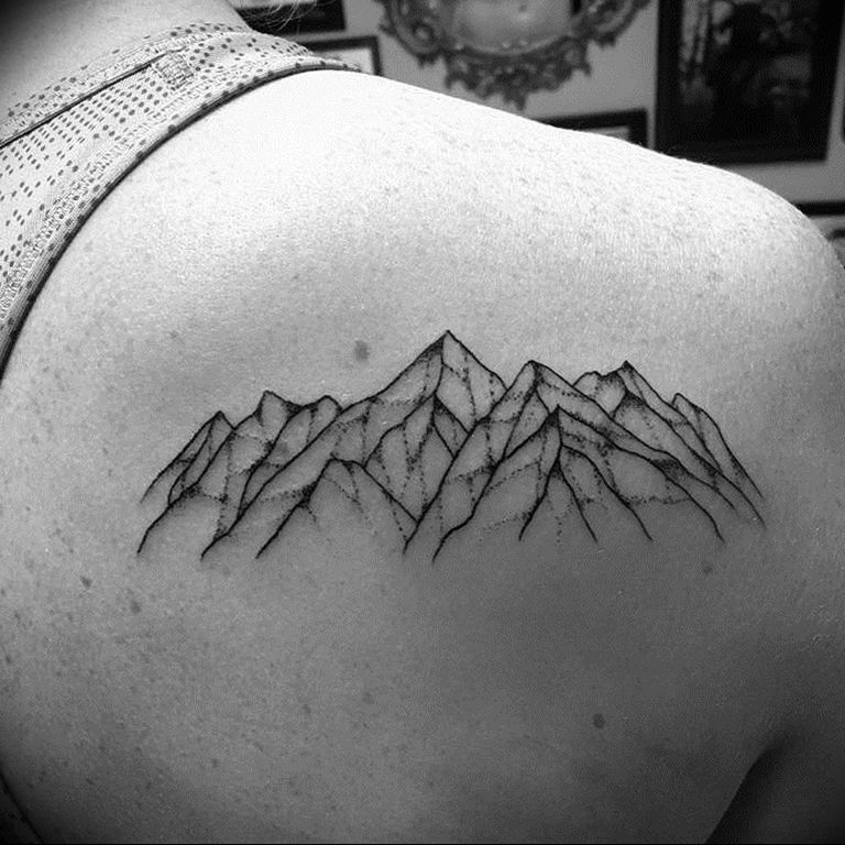 Mountain tattoo on the shoulder blade for men