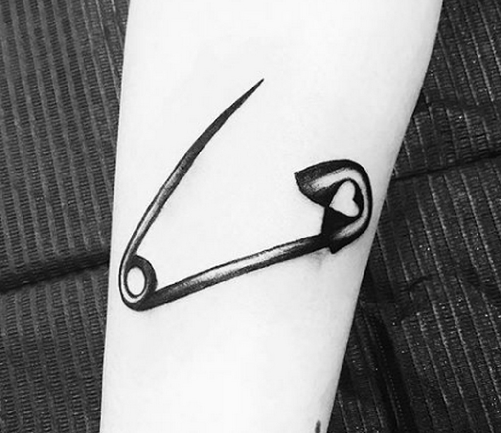 Pin tattoo on arm for women