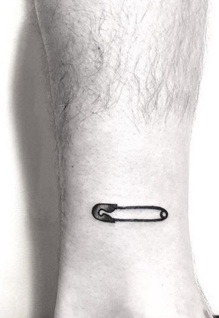 Pin tattoo on the shin for men