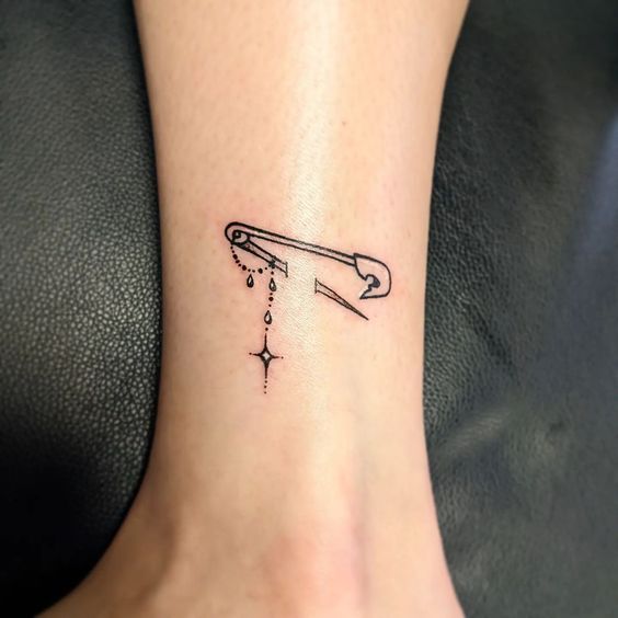 Pin tattoo on the shin for women