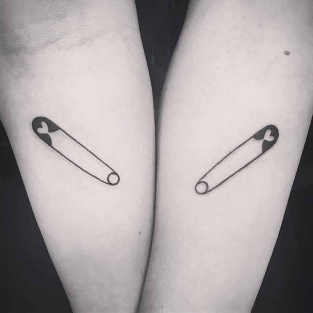 Pin tattoo on arms for women