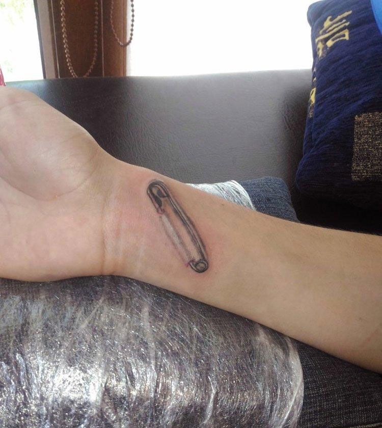 Pin tattoo on forearm for men