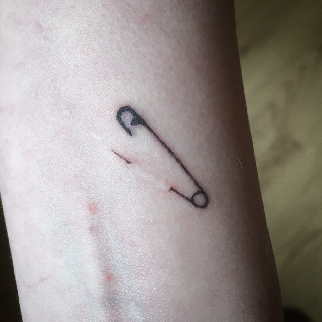 Pins tattoo on forearm for women