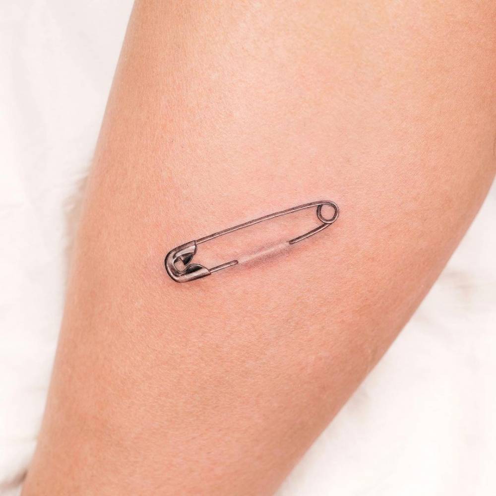 Pin tattoo on arm for women