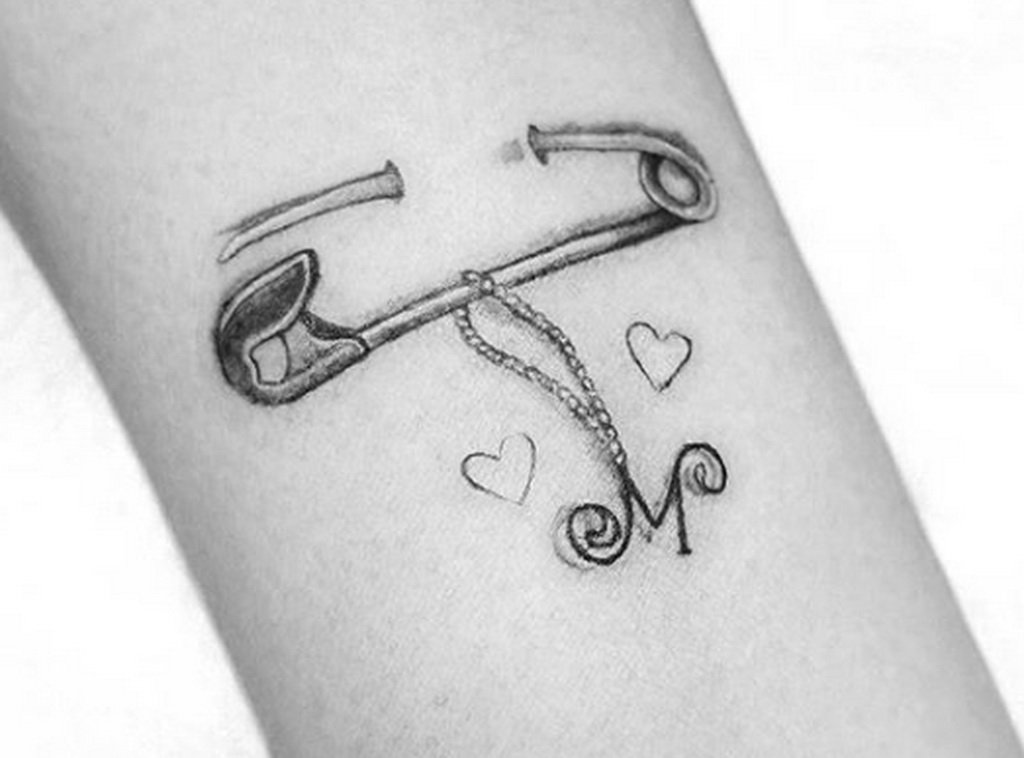 Pin tattoo on arm for women