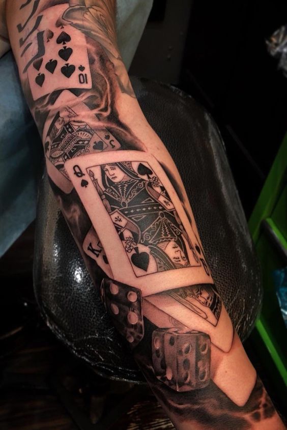 Tattoo of playing cards on the arm for women