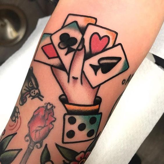 Colorful playing cards tattoo on the arm for men