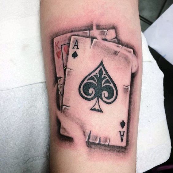 Tattoo of playing cards on the arm for men