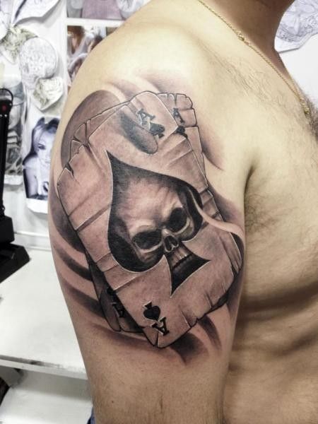 Tattoo of playing cards on the shoulder for men