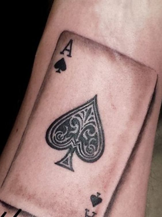 Tattoo of playing cards on the arm for men