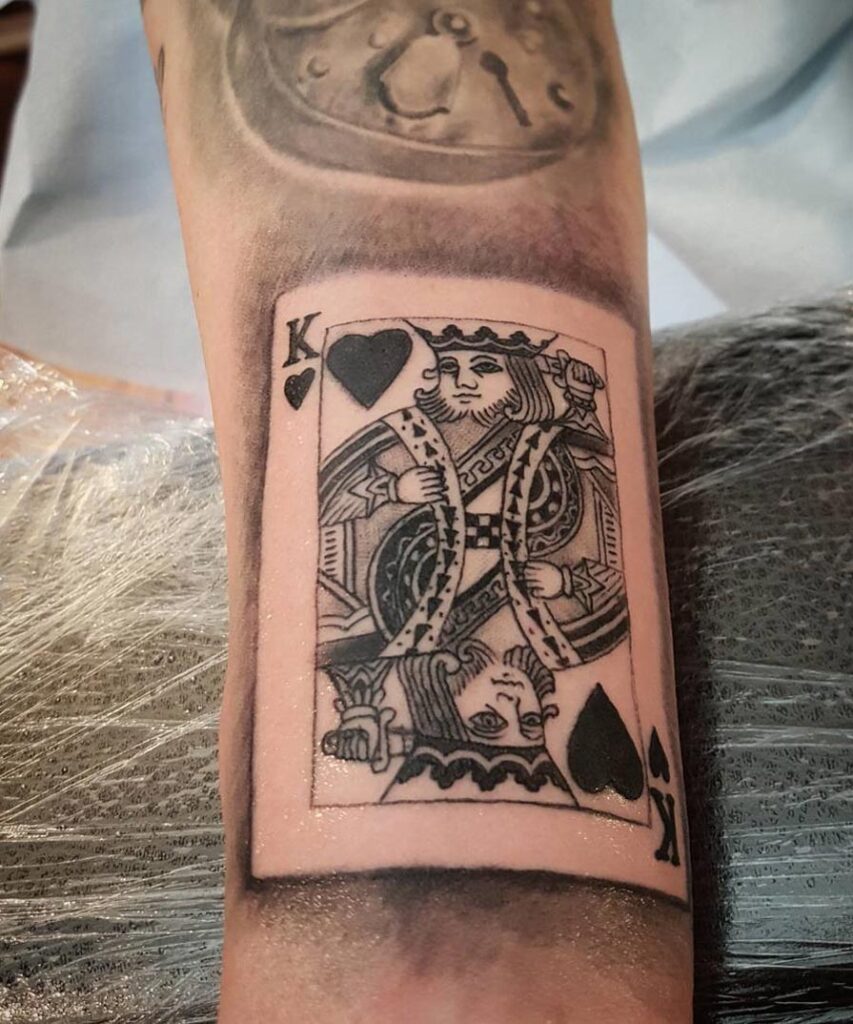 Tattoo of playing cards on the arm for men