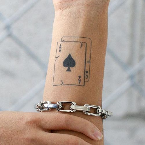 Playing cards tattoo on forearm for women