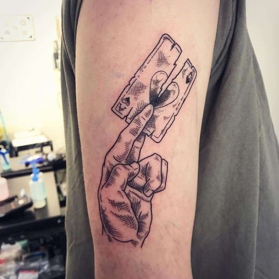 Tattoo of playing cards on the shoulder for men