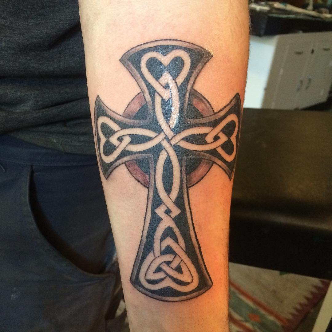 Celtic cross tattoo on forearm for men