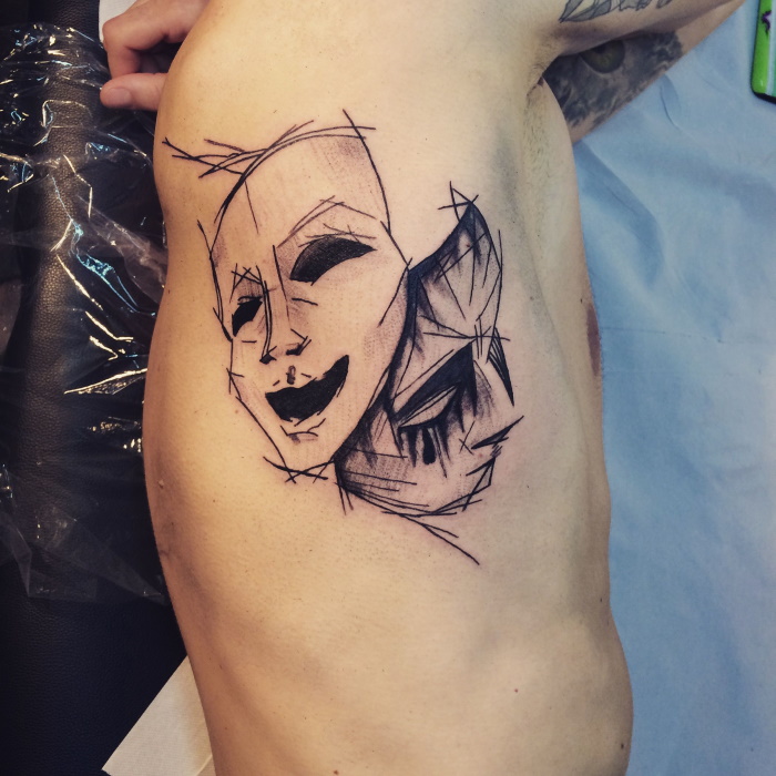 Tattoo of two masks in sketch style on the side for men