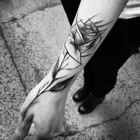 Sketch style rose tattoo on forearm for men