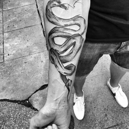 Sketch style snake tattoo on forearm for men