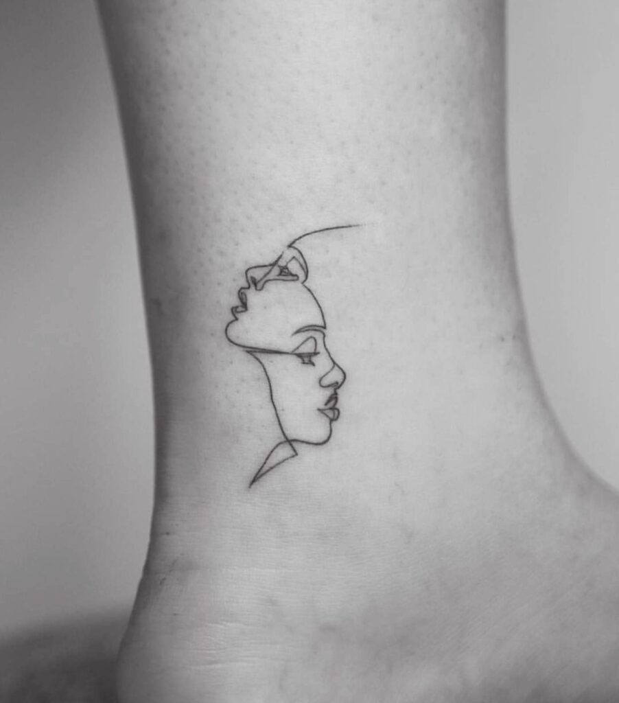 Minimalist style tattoo on the leg for women