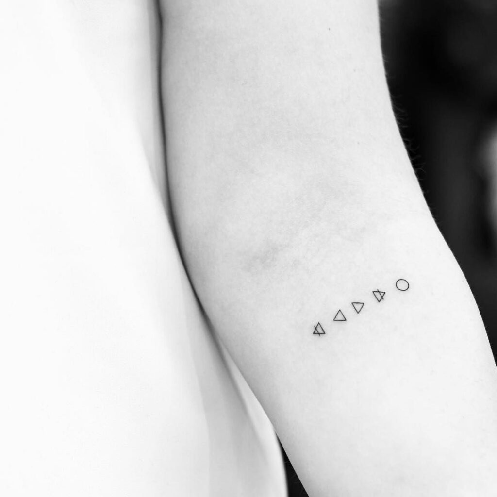 Minimalist style tattoo on the forearm for women