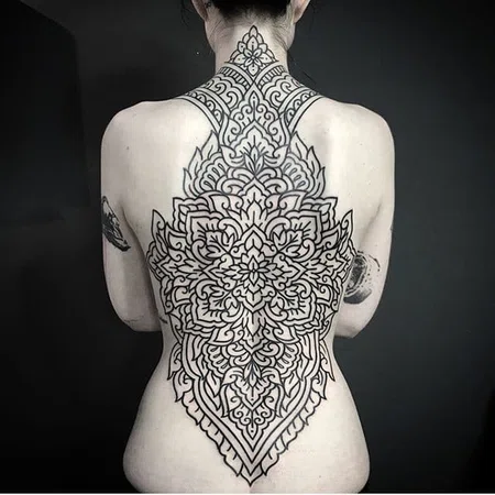 Ornamental style tattoo on the back for women