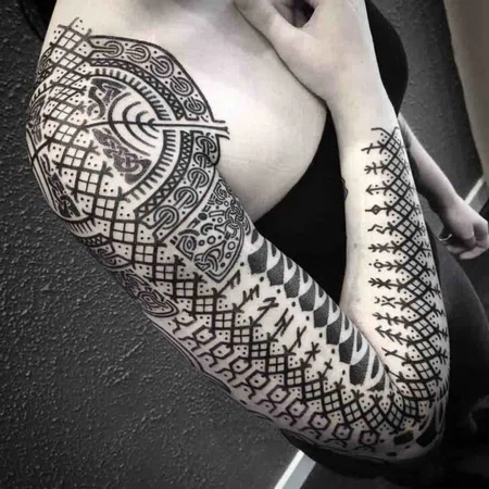 Ornamental style tattoo on the arm for women